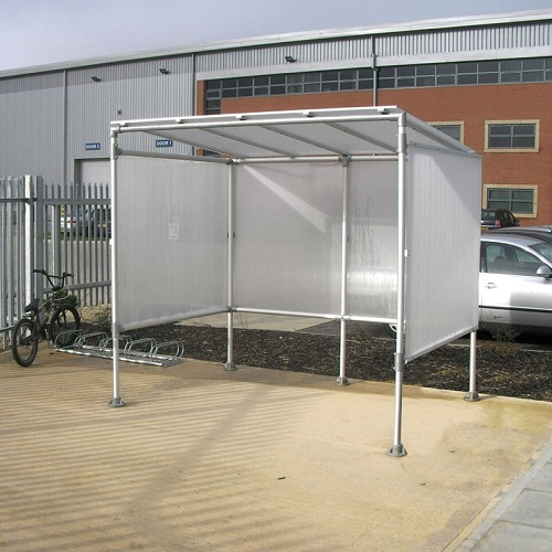 Aluminium smoking shelter outside a building. 